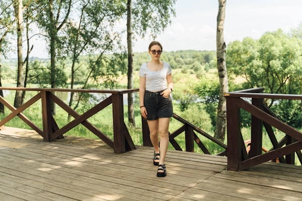 Stylish outfit featuring low-rise jean shorts paired with a trendy top and accessories, showcasing different ways to style them for various occasions.