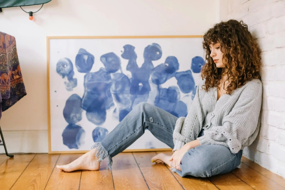 A woman showcasing the benefits of mid-rise jeans, highlighting their comfort and flattering fit. The image features her wearing stylish mid-rise jeans paired with a casual top, perfect for everyday wear